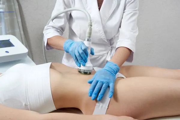 Lost the Weight but Not the Loose Skin? 2 woman having HIFU treatment on her stomach to combat loose skin Garston following weight loss